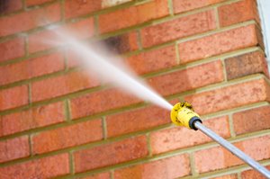 brick wall being pressure washed