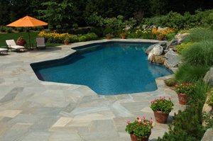 backyard pool with slabstone deck